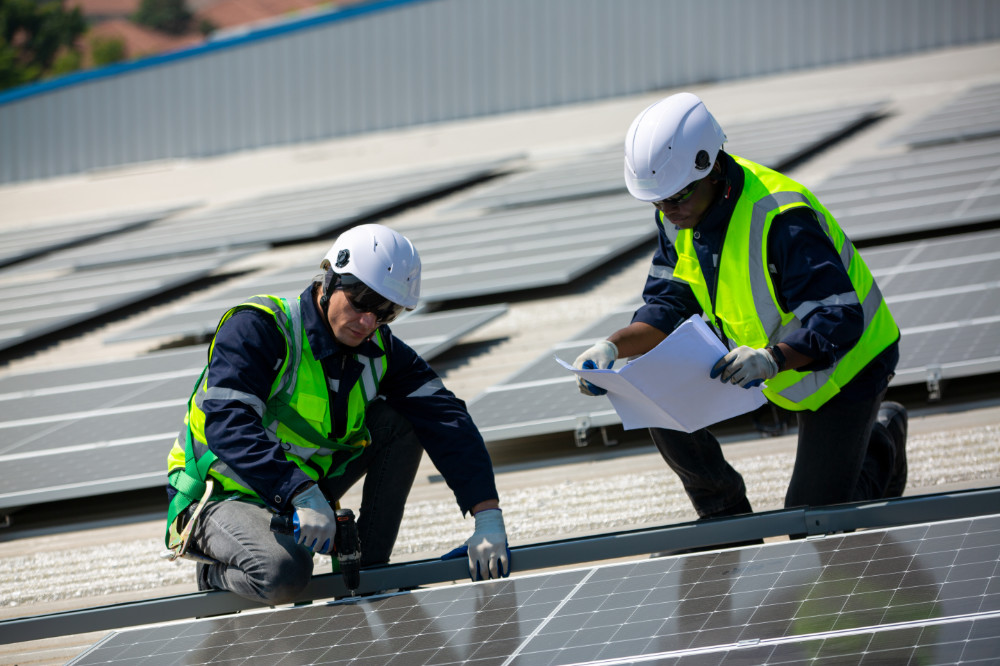 Technology solar cell, Engineer service check installation solar cell on the roof of factory. technician checks the maintenance of the solar panels, engineering team working on checking and maintenance in solar power plant to innovation of green energy for life on factory roof.